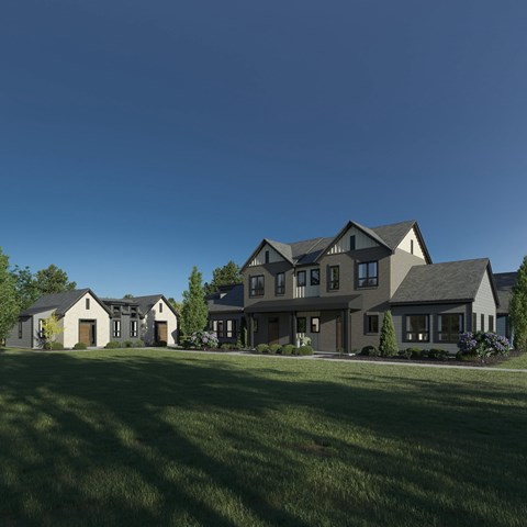 A large, modern house with a grey roof and multiple windows.