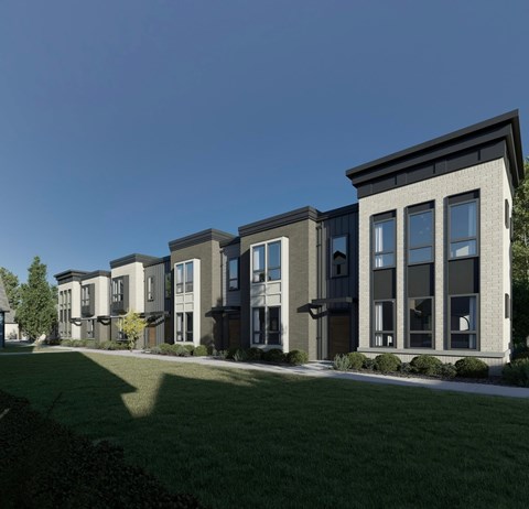 A row of modern townhouses with dark grey and beige exteriors.
