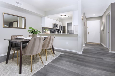 A dining room with a table and chairs.