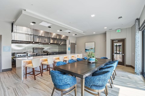 A modern dining room with a long table and chairs.
