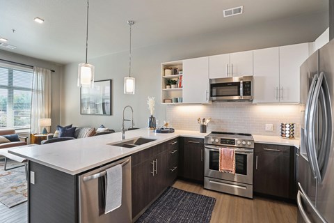 A modern kitchen with a stainless steel oven and refrigerator.