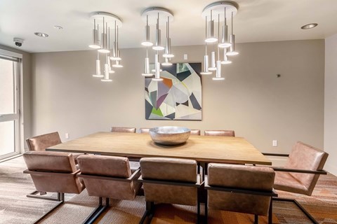 A modern dining room with a large table and chairs.