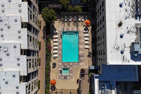 An aerial view of a pool surrounded by buildings.