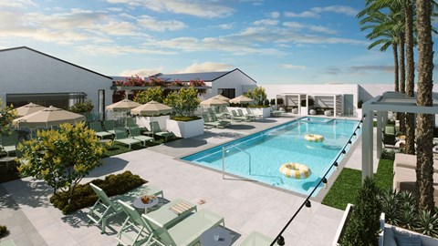 A modern outdoor pool area with lounge chairs and umbrellas.