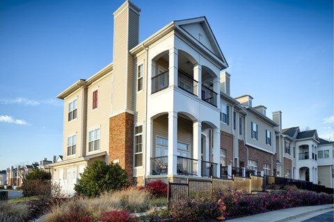 A row of houses with a blue sky in the background.
