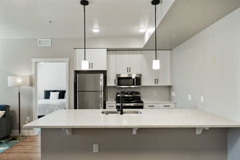 A modern kitchen with a large island in the middle.