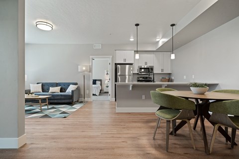 A modern kitchen with a dining table and chairs.