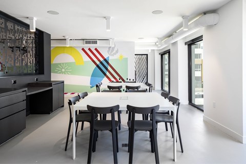 A dining room with a white table and chairs