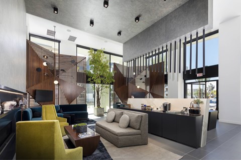 A modern living room with a yellow chair and a grey sofa.