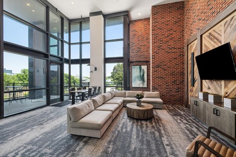 A modern living room with a large sectional sofa and a coffee table.