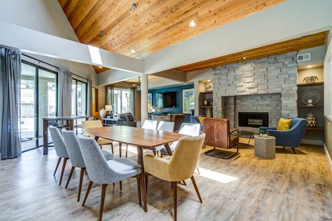 A modern dining room with a wooden table and chairs.