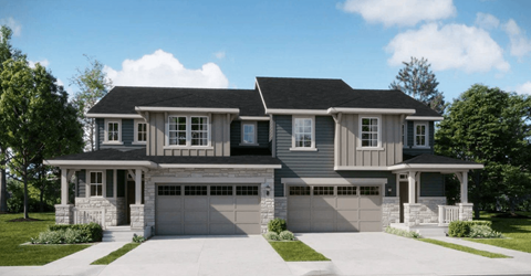 A two-story house with a garage on the first floor and a balcony on the second floor.