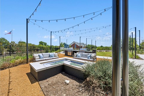 A backyard with a bench and a fence.