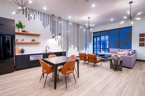 A modern kitchen with a dining table and chairs.
