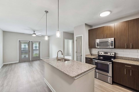 A kitchen with a stove top oven and microwave above it.