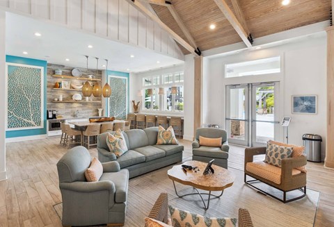A spacious living room with a grey sofa set and a wooden coffee table.