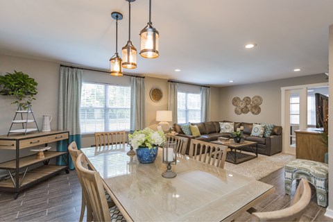A dining room with a table set for six.