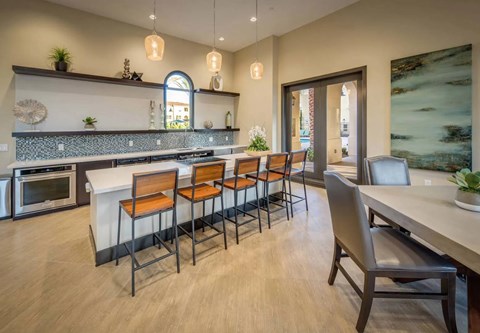 A modern kitchen with a large island and bar stools.