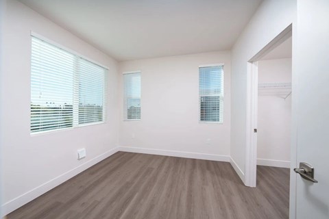 A room with a wooden floor and white walls.