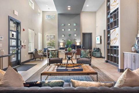 A modern living room with a dark grey sofa and a wooden coffee table.