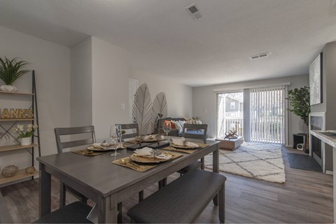 A dining room with a table set for a meal.