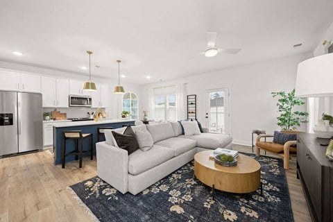 A modern living room with a grey couch and a coffee table.