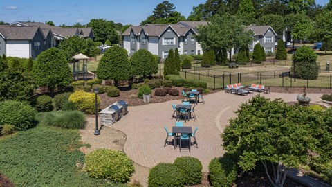A park with a gazebo and picnic tables.