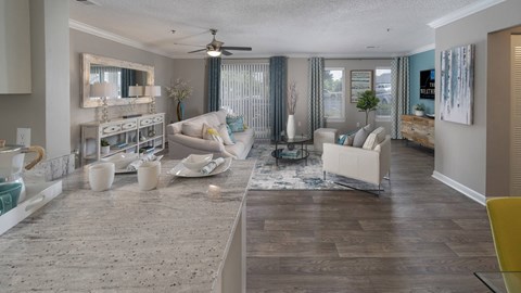 A living room with a white couch and a coffee table.