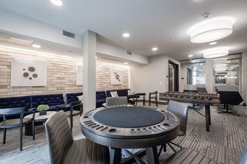 A modern dining room with a round table and chairs.