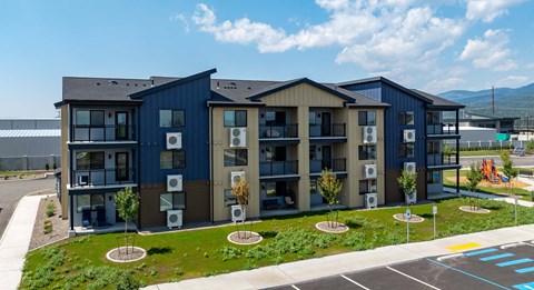 A modern apartment complex with blue and brown exterior.