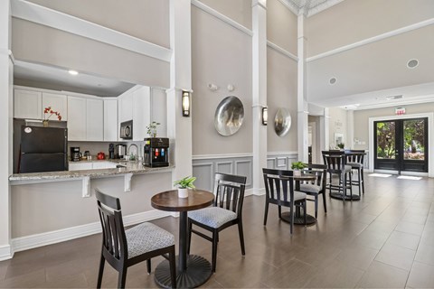 A dining room with a table set for four.