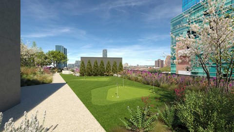 A green space with a small putting green in the middle.