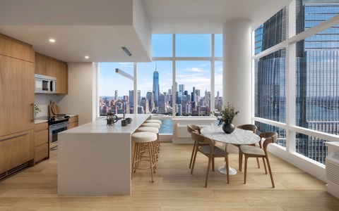 A modern kitchen with a dining table and chairs with a view of the city.