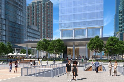 A group of people are walking around a plaza with a large building in the background.
