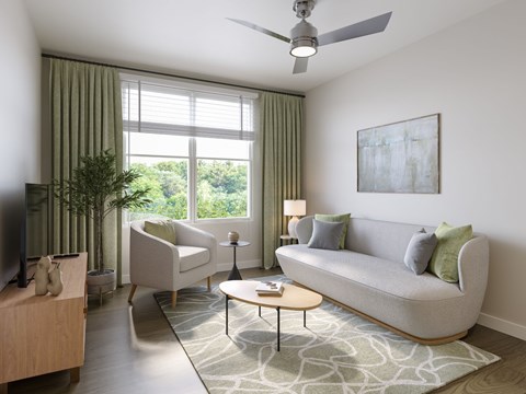 A living room with a grey couch, a white armchair, a wooden coffee table, and a television.