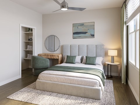 A bedroom with a large bed and a ceiling fan.