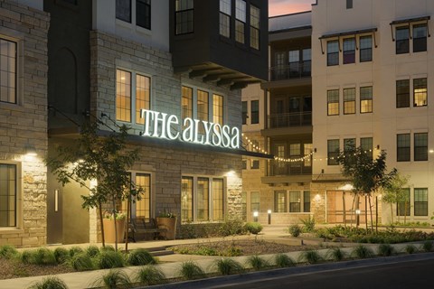 The Alyssa hotel is lit up at night.