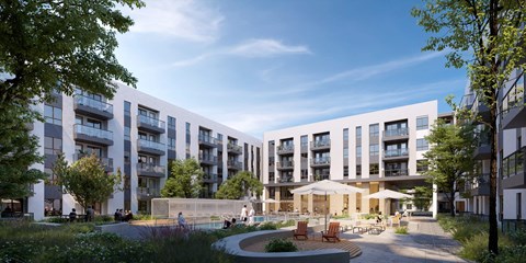 A modern apartment complex with a courtyard and seating area.