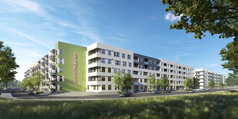 A modern apartment complex with a green building on the left and a white building on the right.