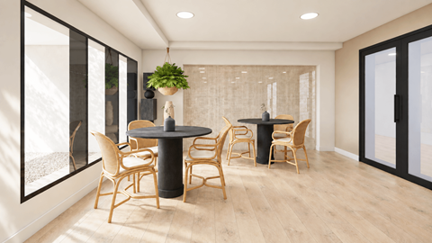 A dining room with a table and chairs.