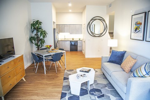 A living room with a grey couch and a white coffee table.