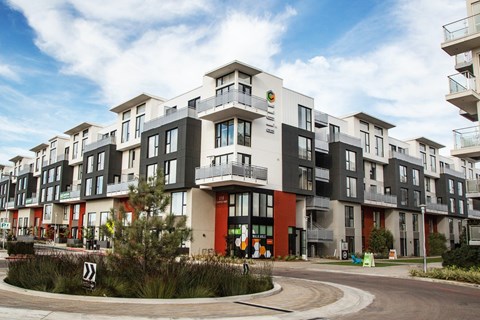 Apartment complex with a mix of black, white, and red colors.