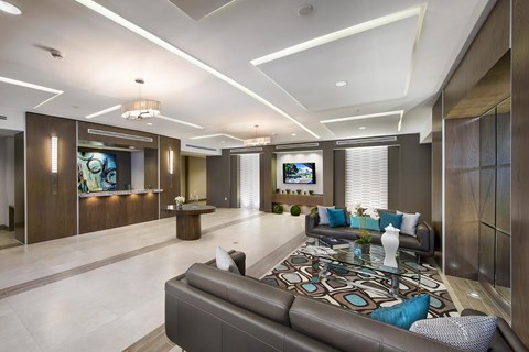 A modern living room with a large couch and a television.