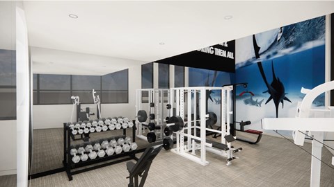 A gym with a variety of equipment including dumbbells, weight plates, and a bench press.