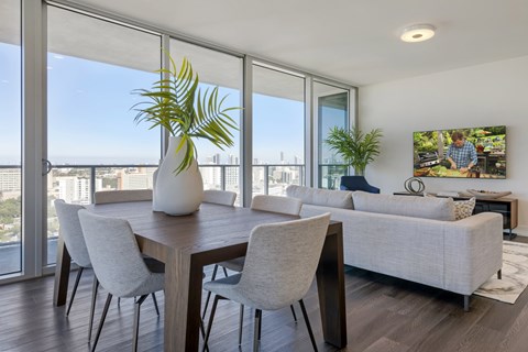 A modern dining room with a view of the city.