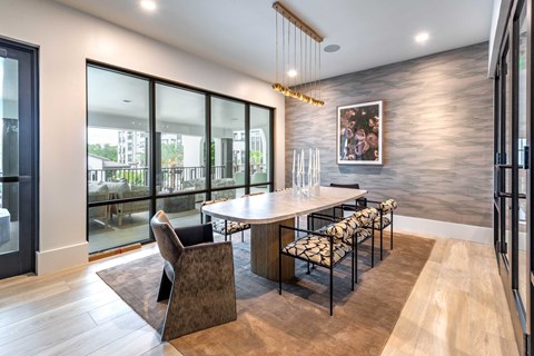 A modern dining room with a large table and chairs.
