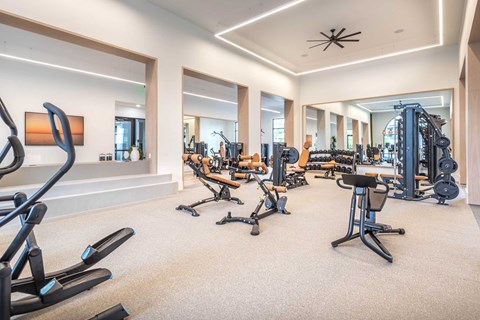 A spacious home gym with a variety of exercise equipment.