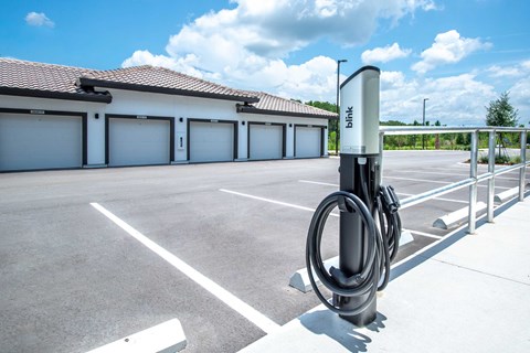 A parking lot with a charging station for electric vehicles.