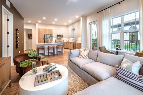 A living room with a grey couch and a round coffee table.