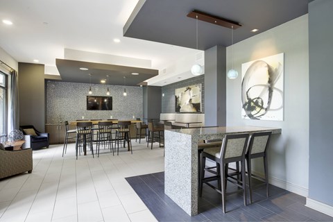 A modern dining room with a bar and chairs.